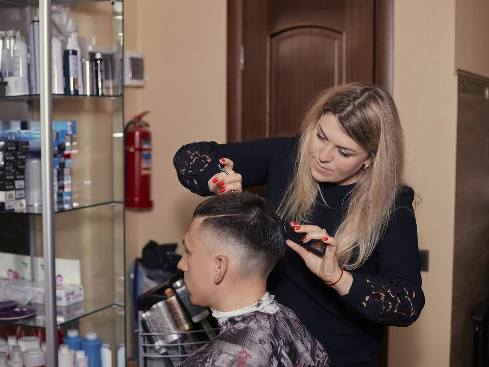 Stock photo of a hairdresser styling a client