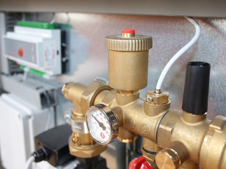 Stock photo of a plumbing valve and gauge assembly