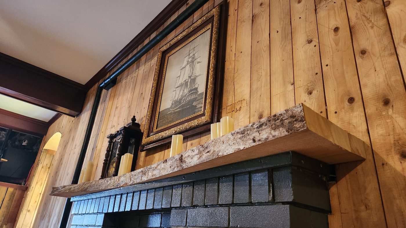 Live-edge elm mantel seen from the side, built by Staged Right Carpentry
