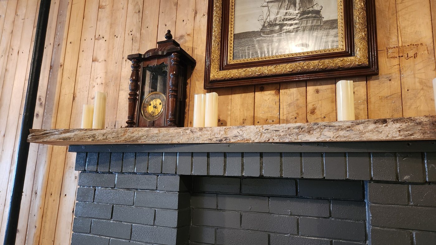 Close view of the live edge along the elm mantel, built by Staged Right Carpentry