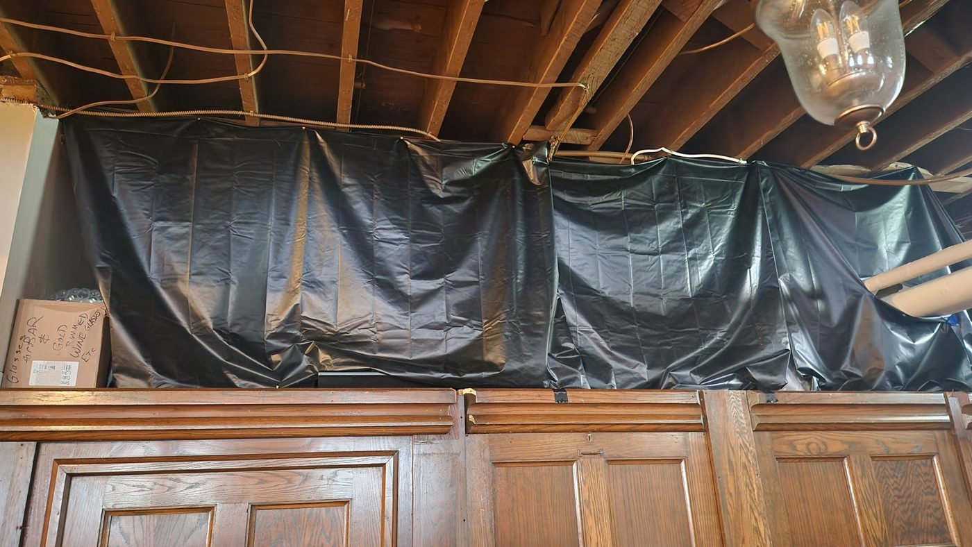 Black plastic curtains hung across the storage space above the stage, before the build
