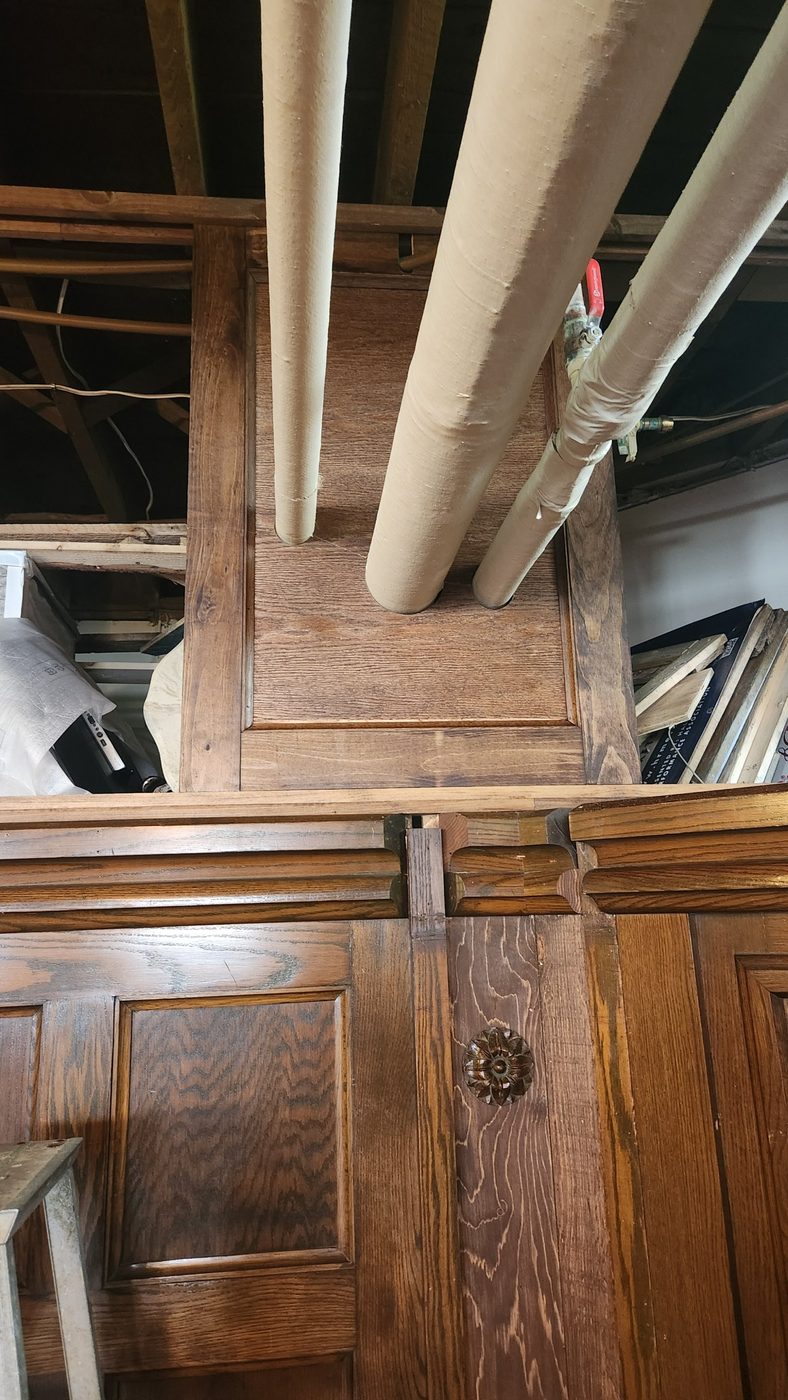 Upper panel with three insulated pipes passing through it, built by Staged Right Carpentry