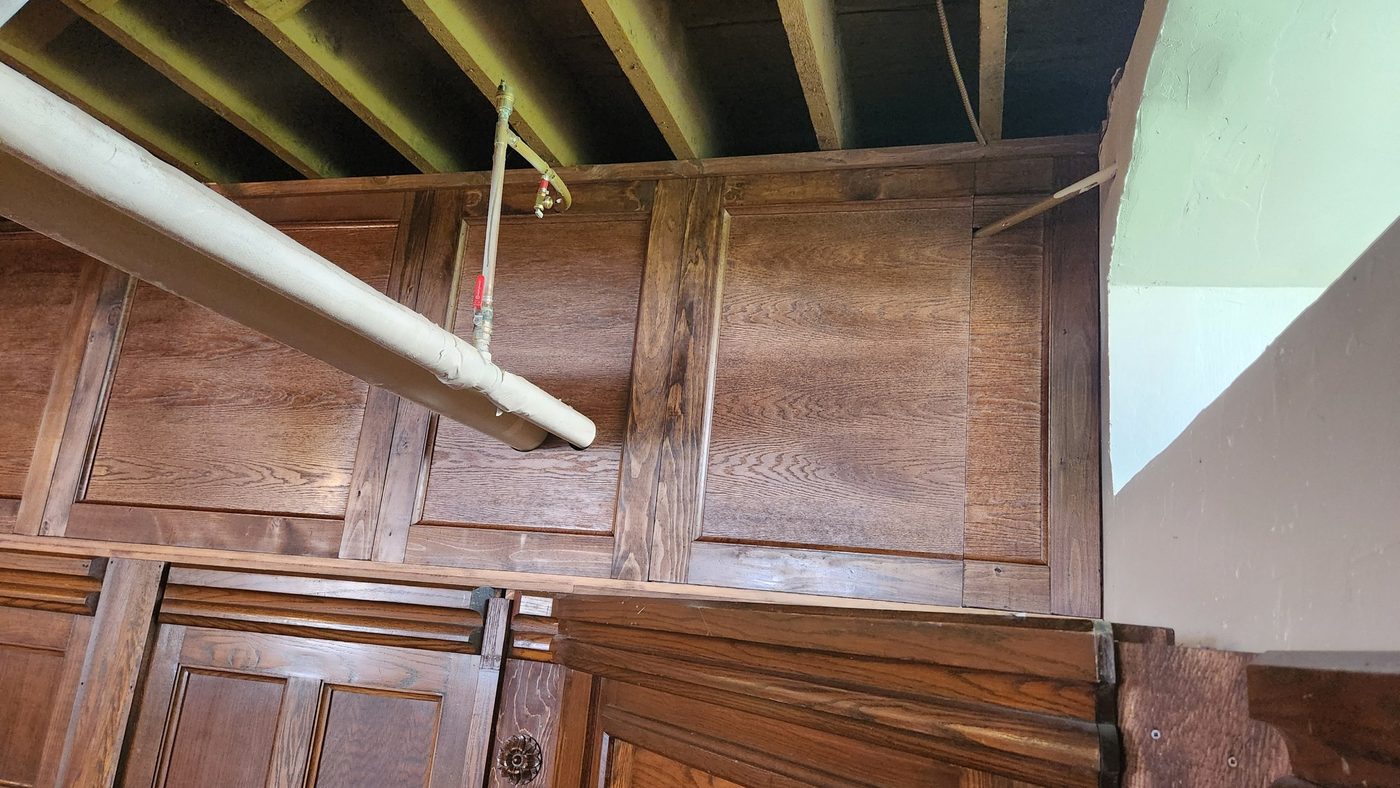 Right-hand storage panel split around a water line and shut-off valve, built by Staged Right Carpentry