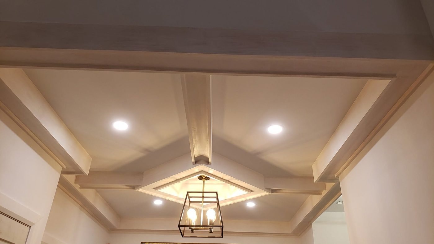 Coffered wood ceiling with recessed lights and a pendant fixture, built by Staged Right Carpentry