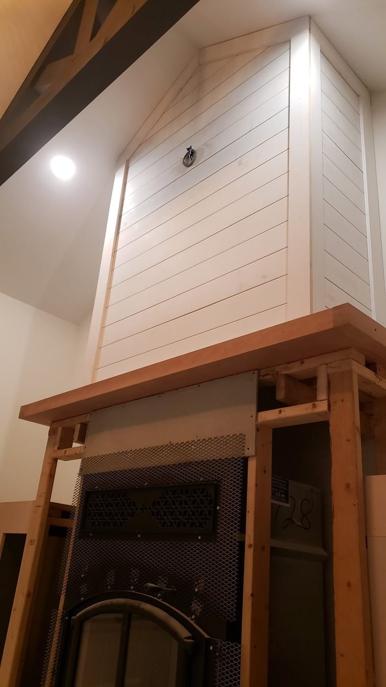 Shiplap chimney surround and wood mantel, photographed during the build, built by Staged Right Carpentry