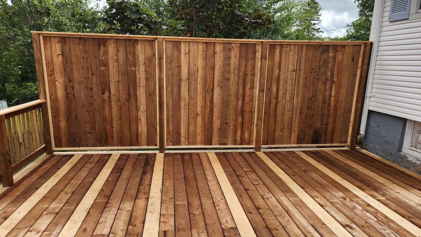Cedar privacy fence panels on a finished deck, built by Staged Right Carpentry